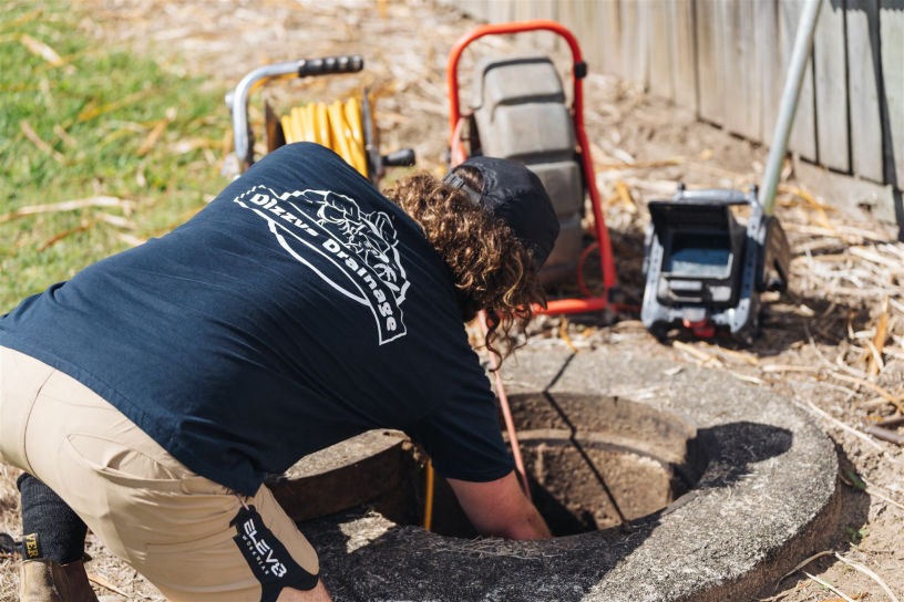 An image of a Dizzys Drainage team member working on a sewer